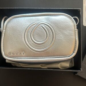 Brand new in box silver small bag w/removable strap. 7 wide x5 high.